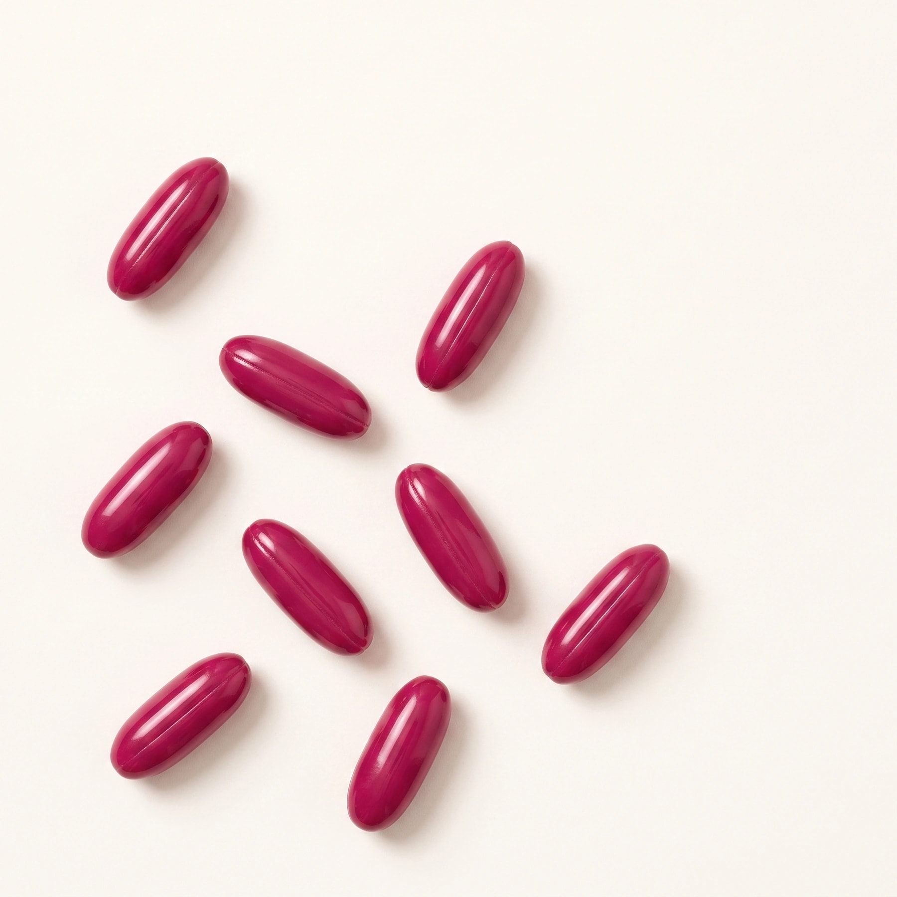 A bottle of Soundbites ACEMg inner ear supplement with two softgel capsules beside it